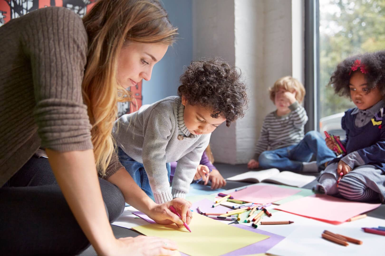 Teacher Drawing With Students On Floor Kids Thrive